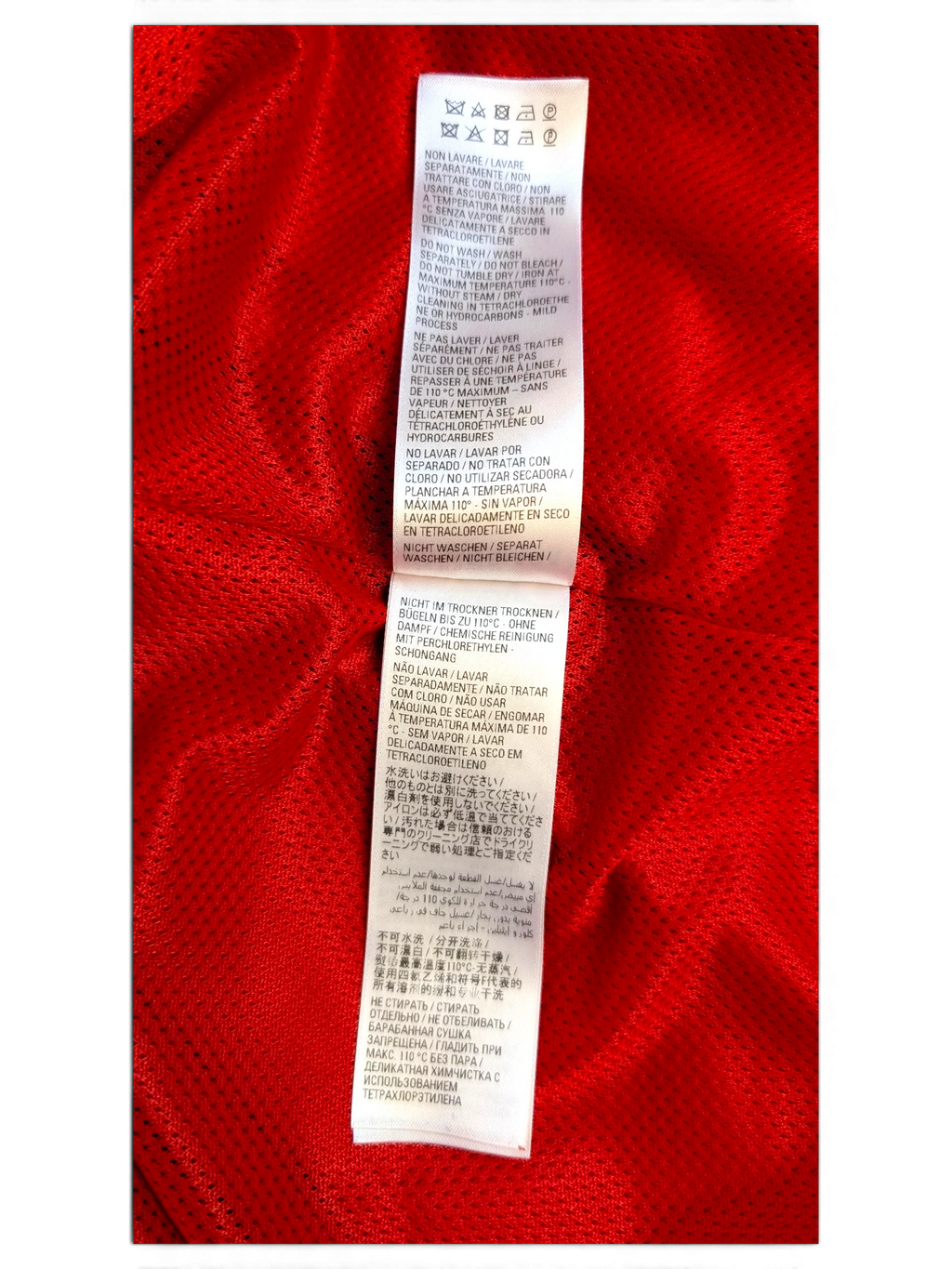 JAKE & IPI Balenciaga x Adidas clothing care label with multi-language washing instructions on red fabric
