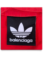 JAKE & IPI Balenciaga x Adidas collaboration red garment featuring a black embroidered brand logo patch