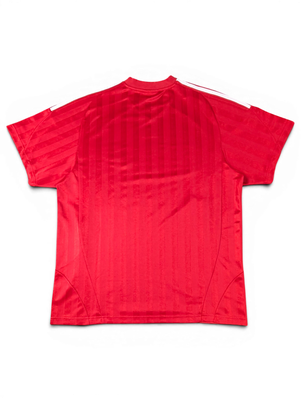 Back view of a red JAKE & IPI Balenciaga x Adidas jersey featuring vertical stripes and white shoulder stripes.