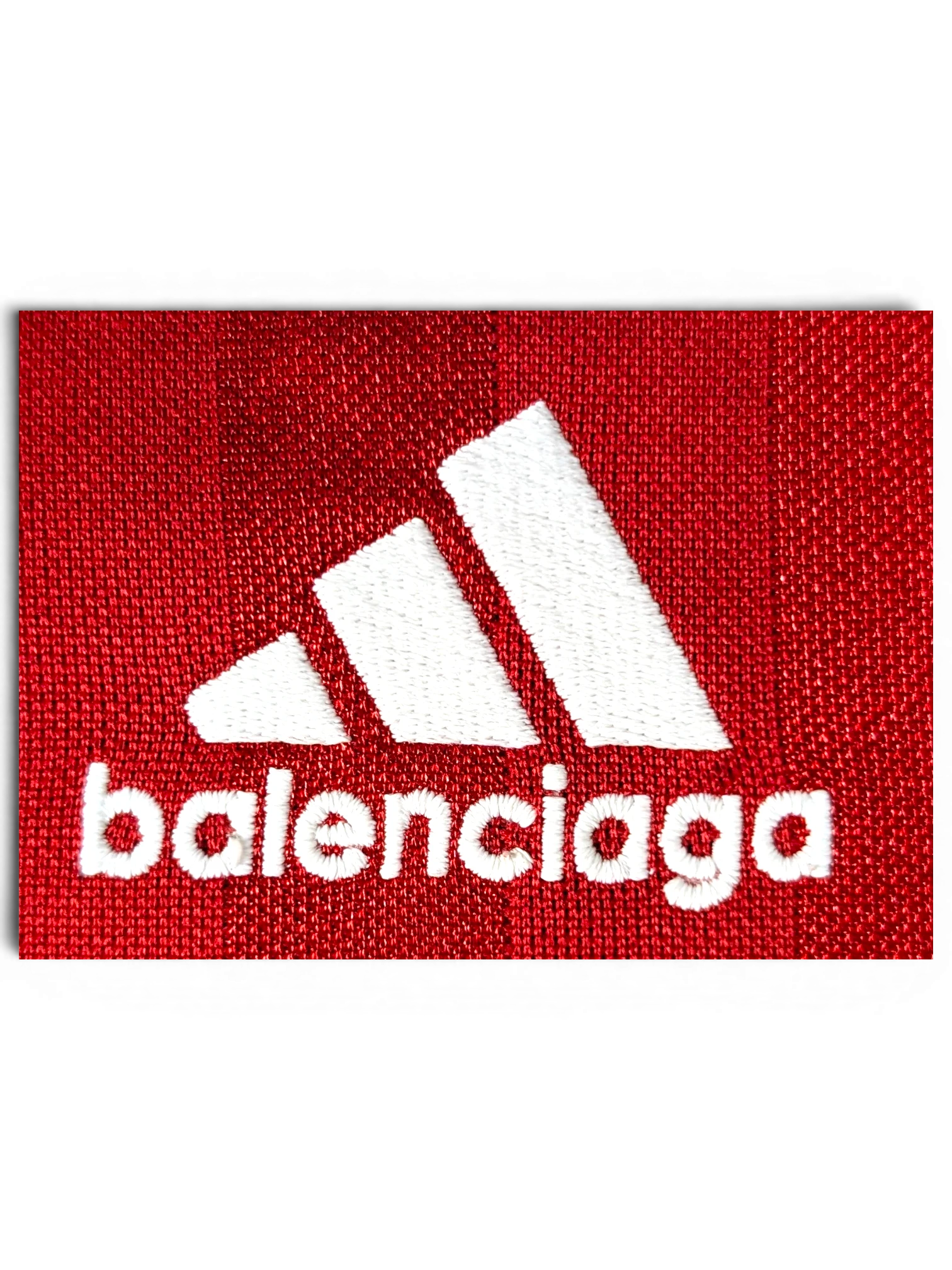 JAKE & IPI Balenciaga x Adidas red jersey featuring white embroidered logo detail on textured fabric