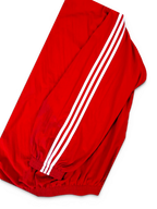 JAKE & IPI Balenciaga x Adidas red track jacket sleeve with signature white three-stripe detailing