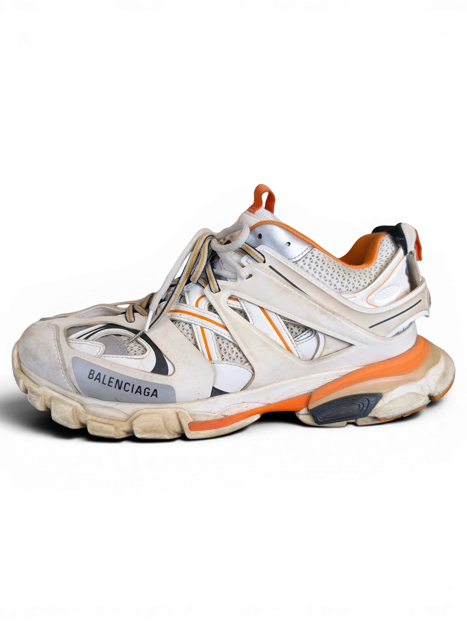 JAKE & IPI Balenciaga Track sneaker in white, grey, and orange with a layered, rugged design and worn-in aesthetic.