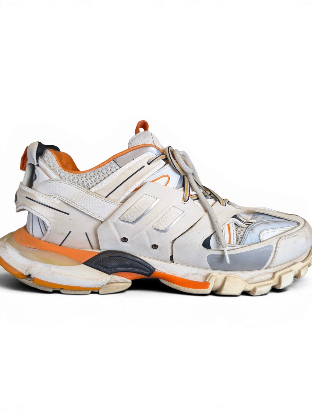 JAKE & IPI Balenciaga Track sneakers in white, grey, and orange with a rugged, layered design and chunky sole.