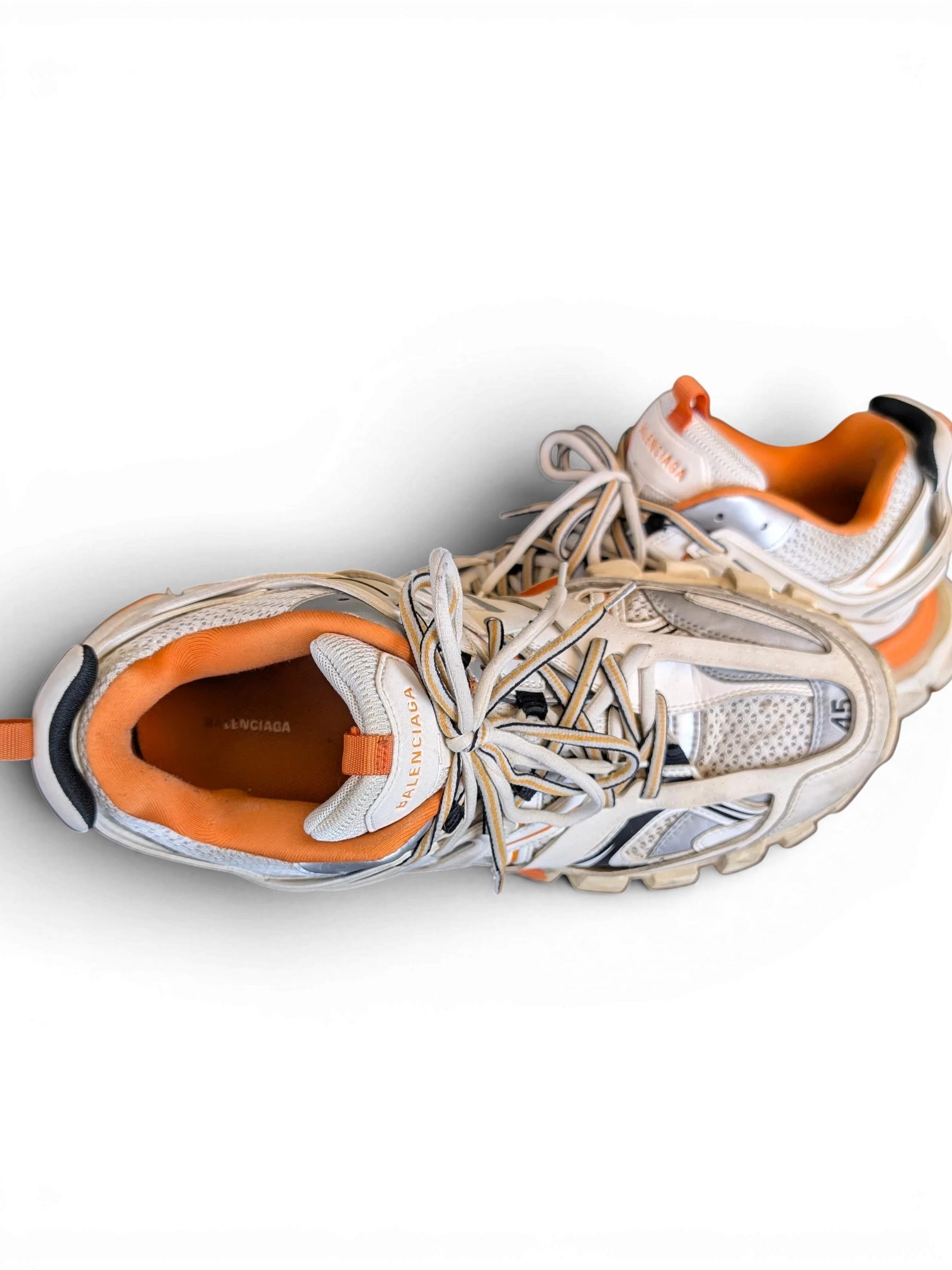 JAKE & IPI Balenciaga Track sneakers in white, grey, and orange with a layered, rugged design and lace-up closure.