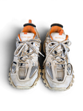 JAKE & IPI Balenciaga Track sneakers in white, grey, and orange with a rugged, layered design and size 45 detail.