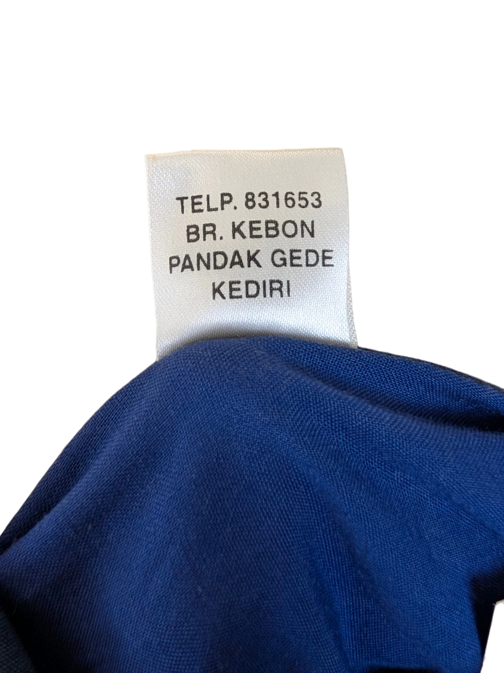 JAKE & IPI Bali Eva Hawaiian shirt fabric label detail showing manufacturing location and contact information