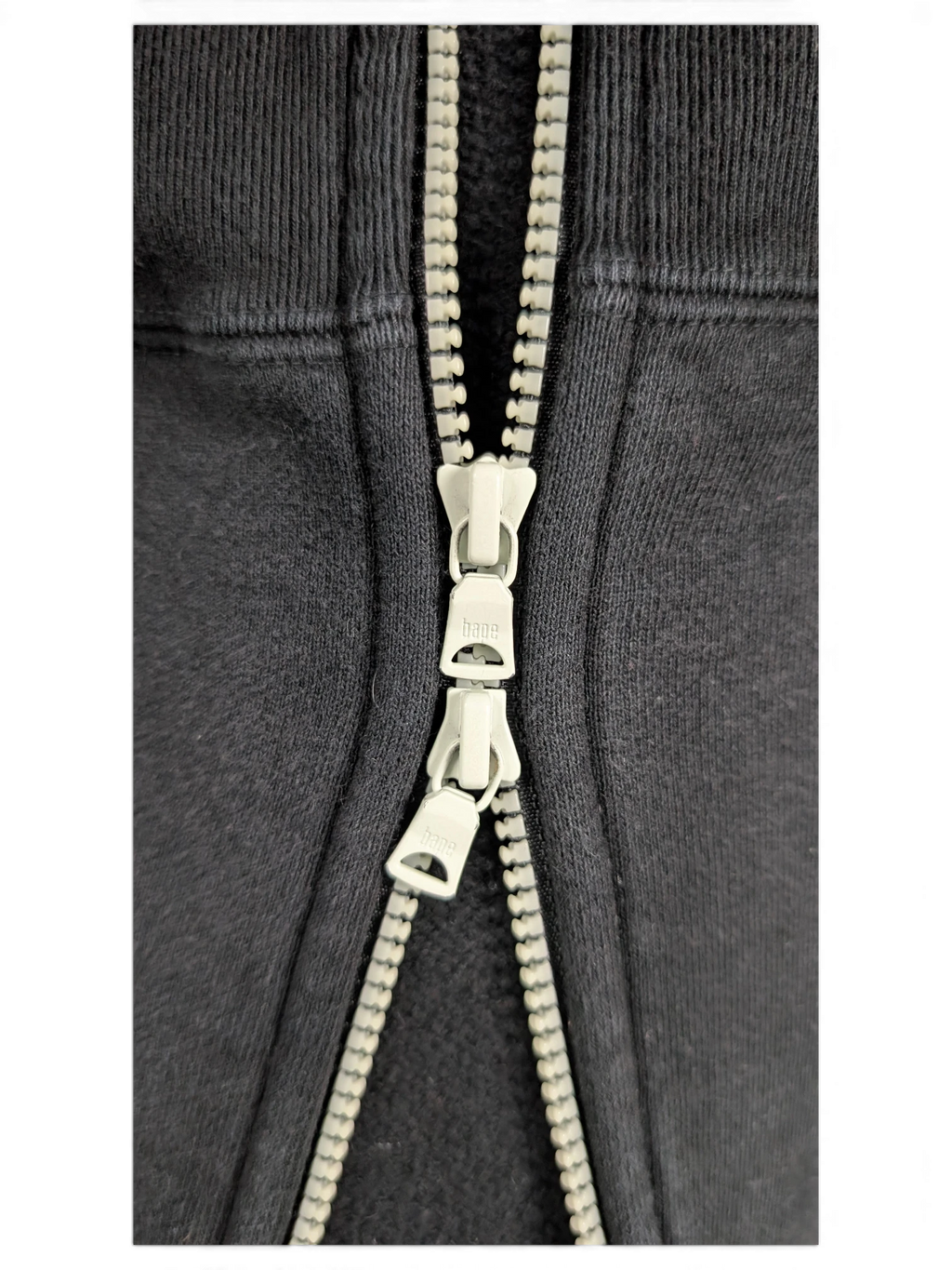 JAKE & IPI black Bape Shark hoodie featuring a detailed close-up of the branded double zipper pull hardware.