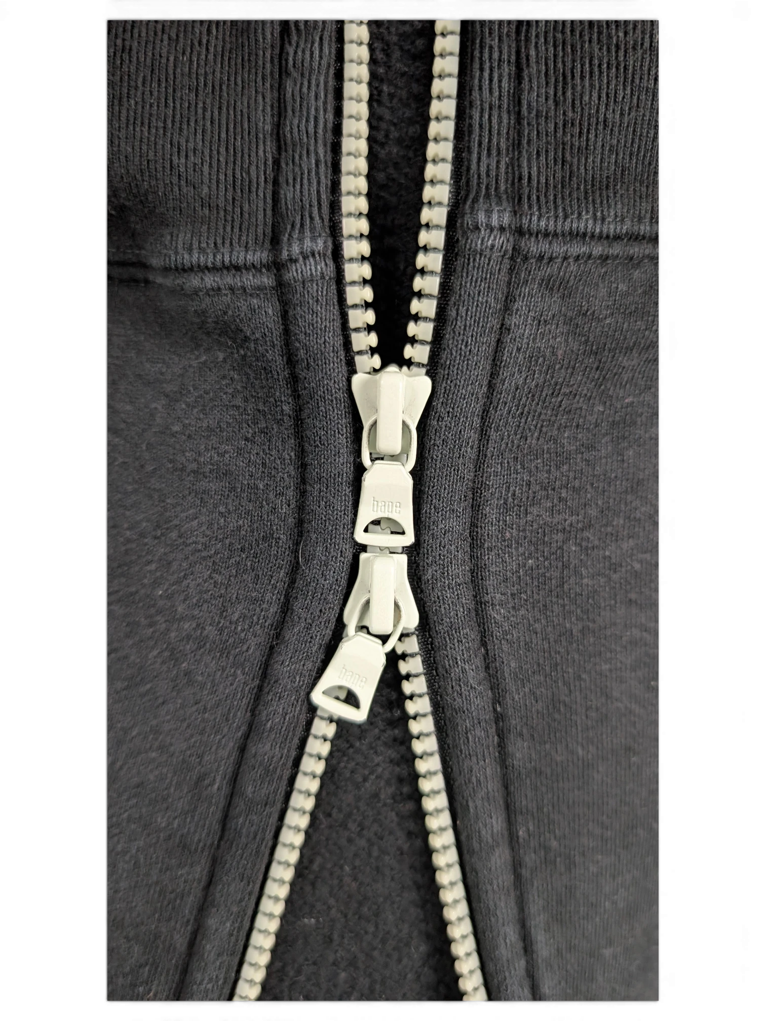 JAKE & IPI black Bape Shark hoodie featuring a detailed close-up of the branded double zipper pull hardware.