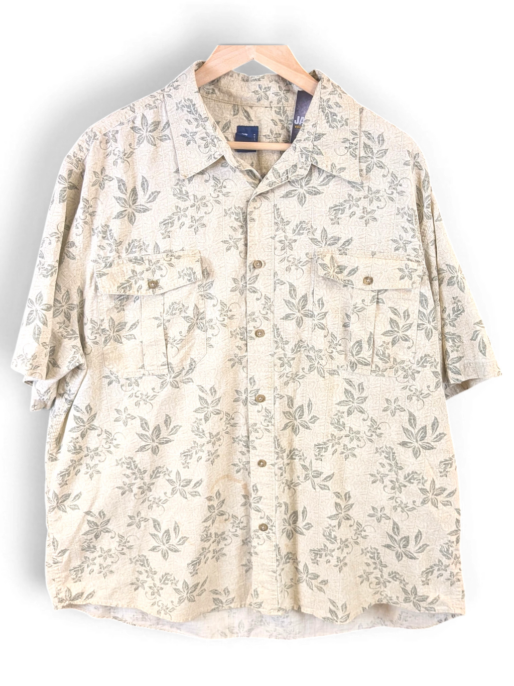 JAKE & IPI beige Hawaiian shirt with a subtle green leaf print, featuring a button-down front and dual chest pockets.