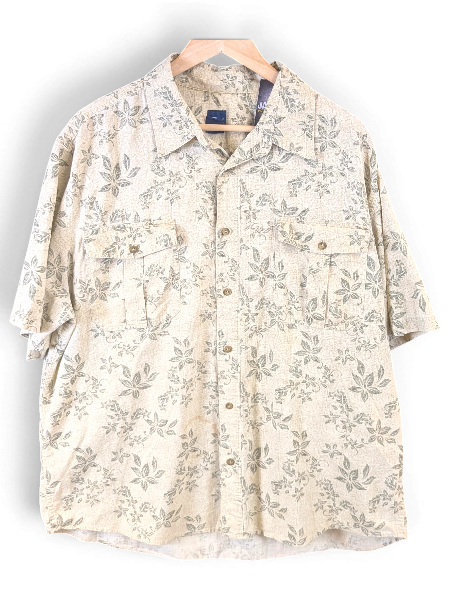 JAKE & IPI beige Hawaiian shirt with a subtle green leaf print, featuring a button-down front and dual chest pockets.