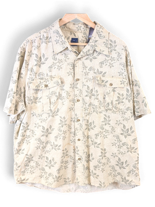 JAKE & IPI beige Hawaiian shirt with a subtle green leaf print, featuring a button-down front and dual chest pockets.