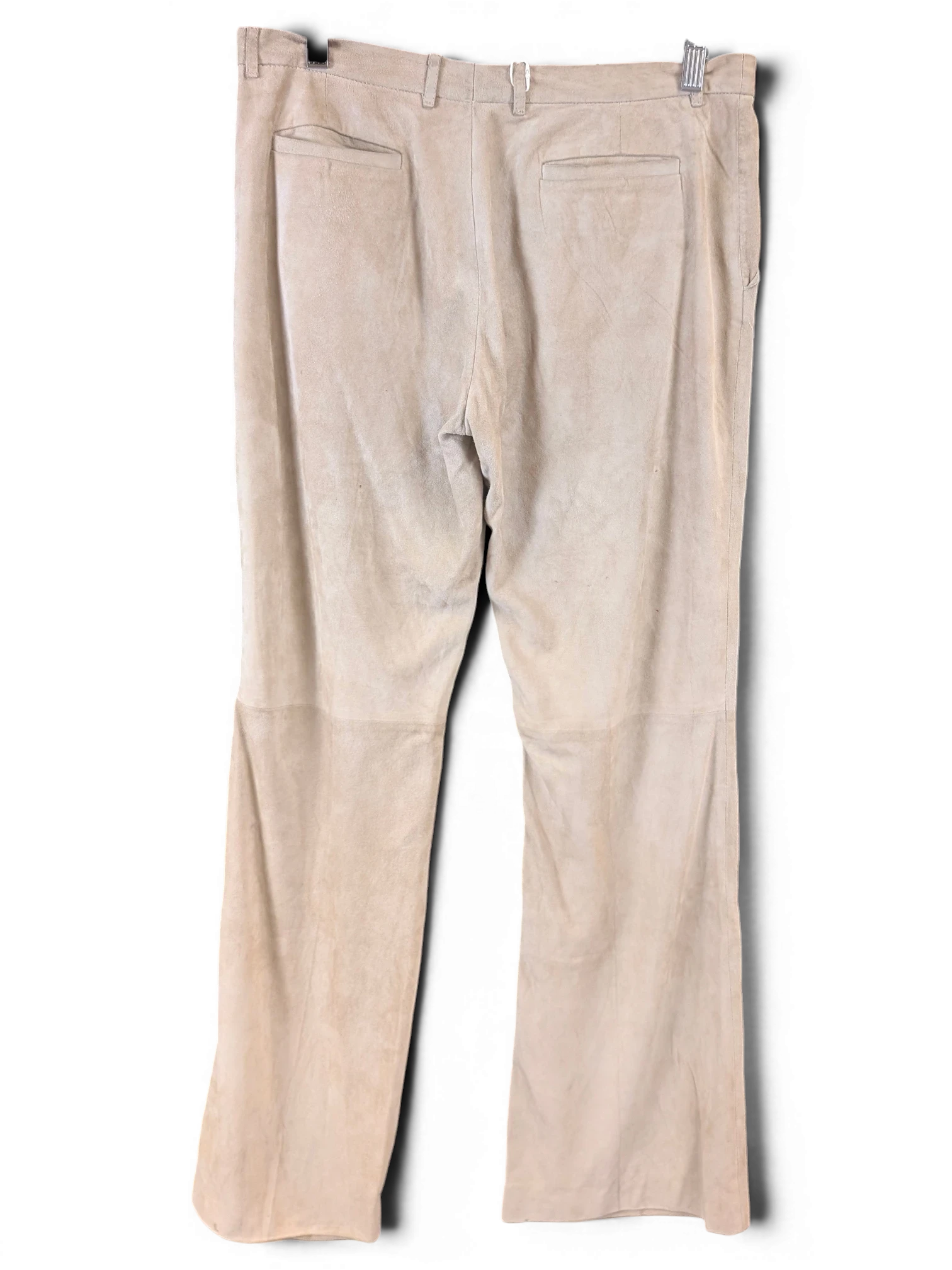 JAKE & IPI beige suede leather pants with back pockets hanging on a wooden hanger against a black background