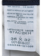 JAKE & IPI vintage beige pleated trousers care label showing size W36 L32 and cotton spandex fabric composition