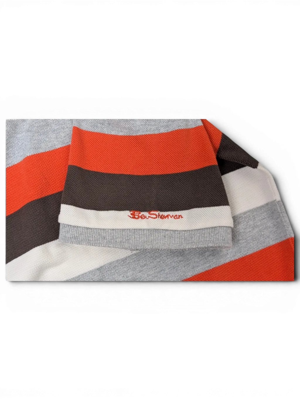 JAKE & IPI vintage Ben Sherman polo shirt sleeve featuring grey, red, black, and white horizontal stripes.