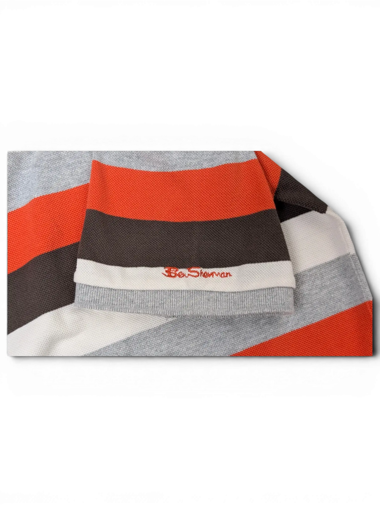 JAKE & IPI vintage Ben Sherman polo shirt sleeve featuring grey, red, black, and white horizontal stripes.