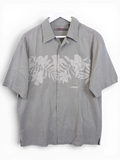JAKE & IPI grey Billabong Hawaiian shirt with a subtle floral print and button-down front on a white hanger