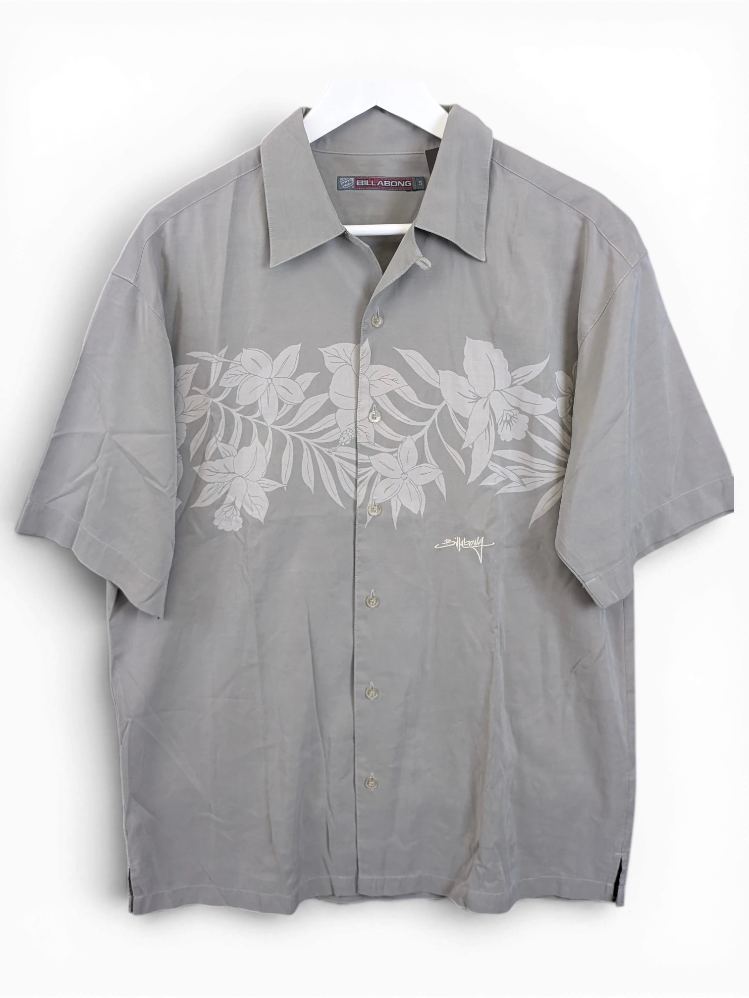 JAKE & IPI grey Billabong Hawaiian shirt with a subtle floral print and button-down front on a white hanger