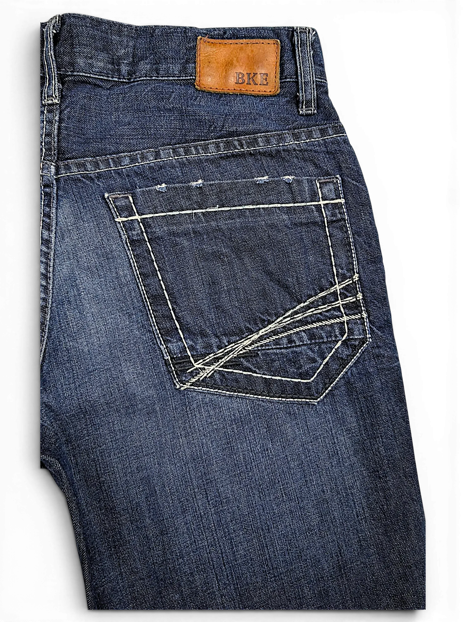 JAKE & IPI BKE Denim Carter jeans in dark wash with distressed back pocket and tan leather brand patch