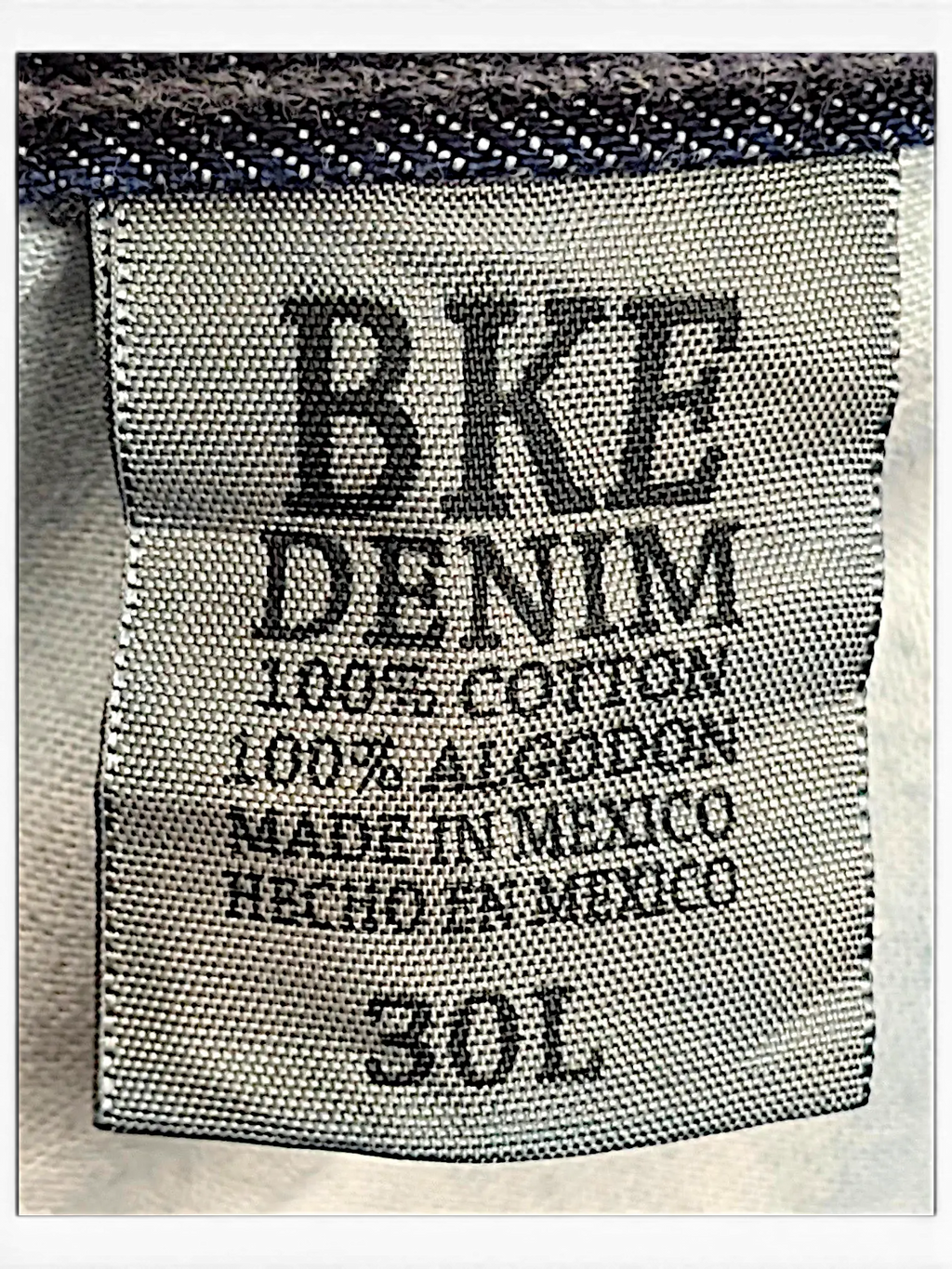 JAKE & IPI BKE Denim Carter 30L jeans interior label showing 100 percent cotton material and size 30L