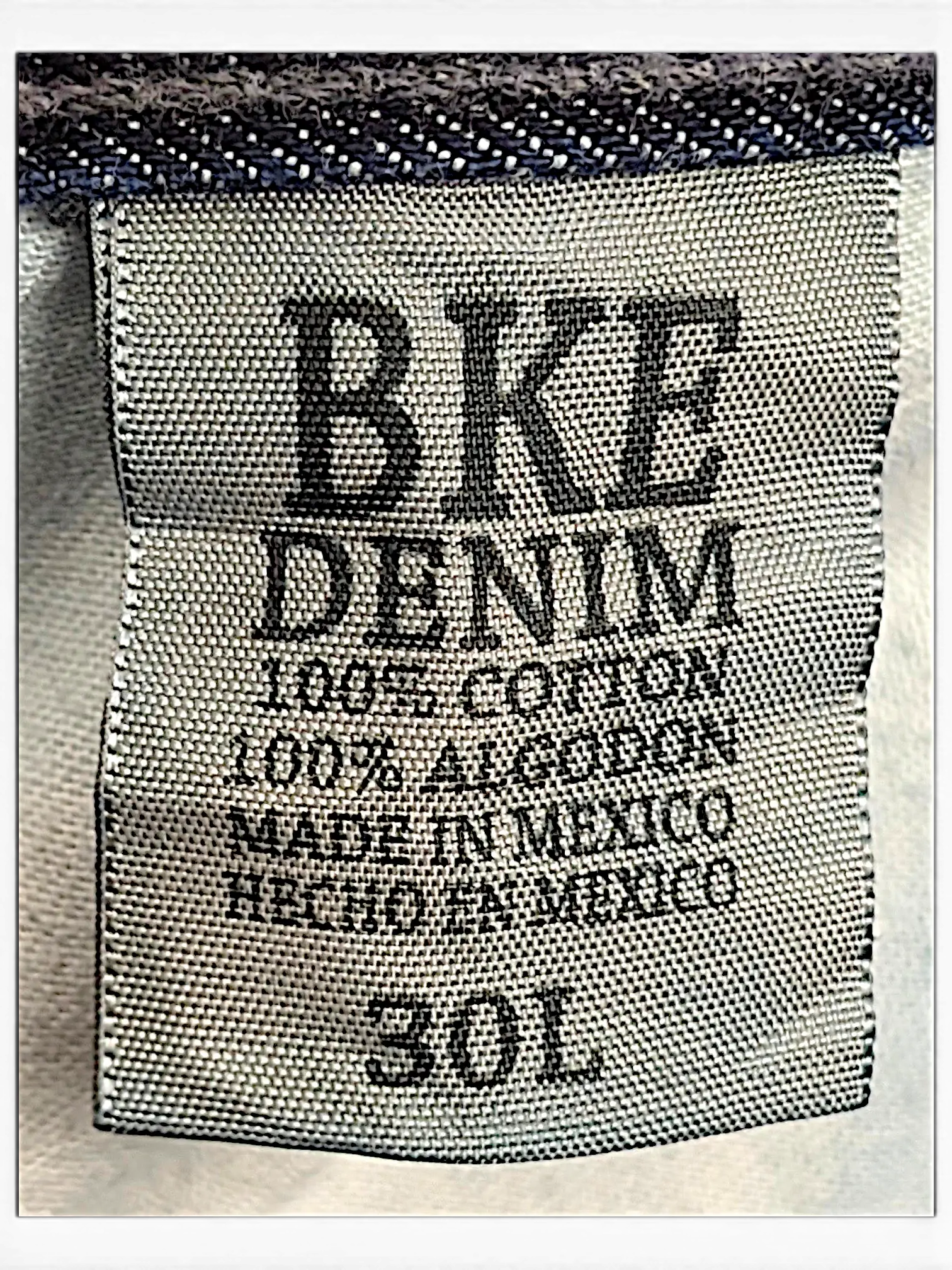 JAKE & IPI BKE Denim Carter 30L jeans interior label showing 100 percent cotton material and size 30L