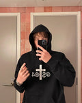 JAKE & IPI black IBE Astra hoodie with white cross and text graphic on the chest worn by a person in a mirror selfie