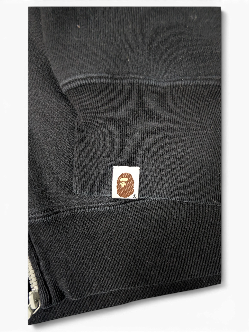 JAKE & IPI black Bape Shark hoodie sleeve featuring the iconic embroidered ape head logo patch on the ribbed cuff.