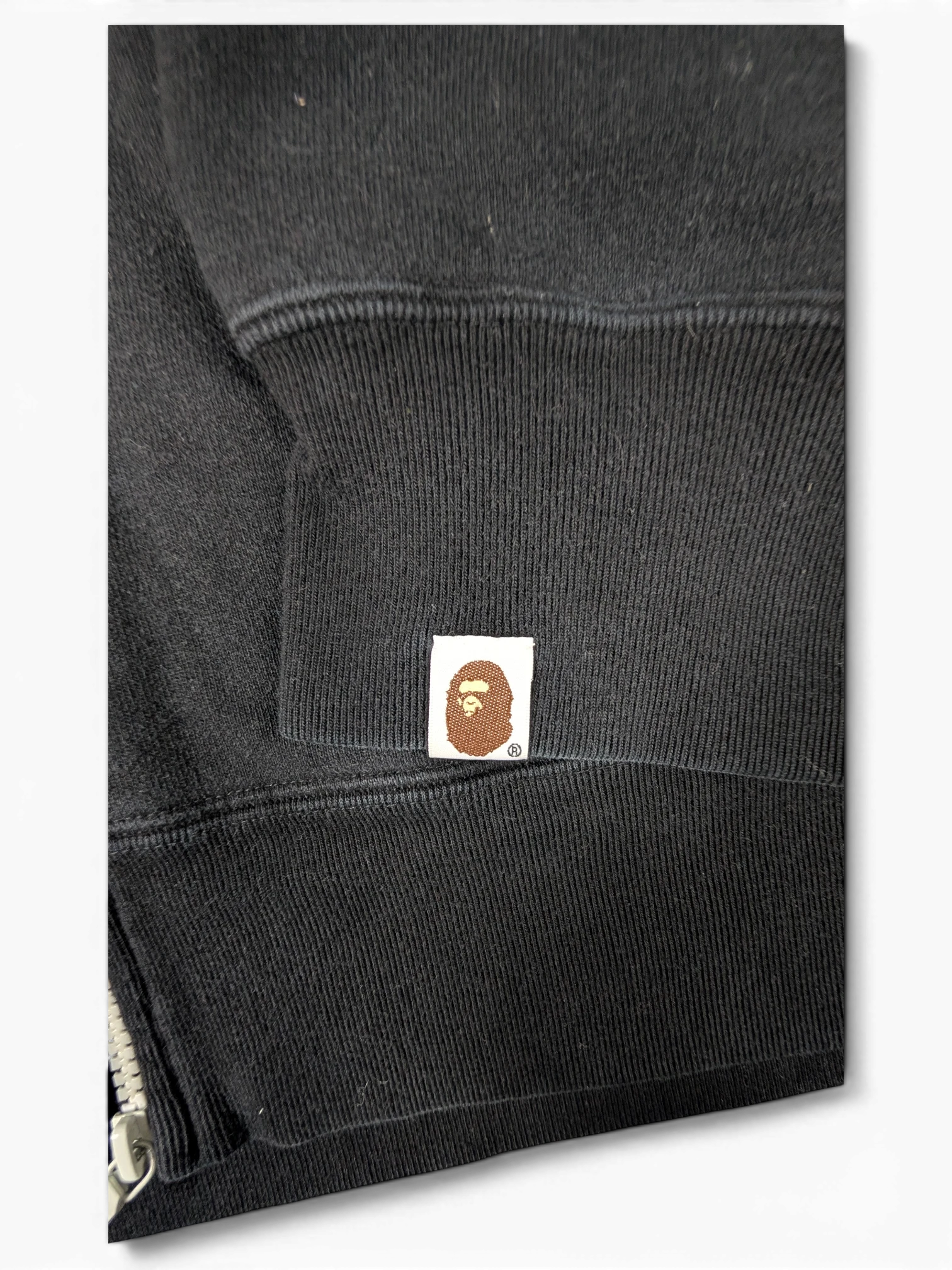 JAKE & IPI black Bape Shark hoodie sleeve featuring the iconic embroidered ape head logo patch on the ribbed cuff.