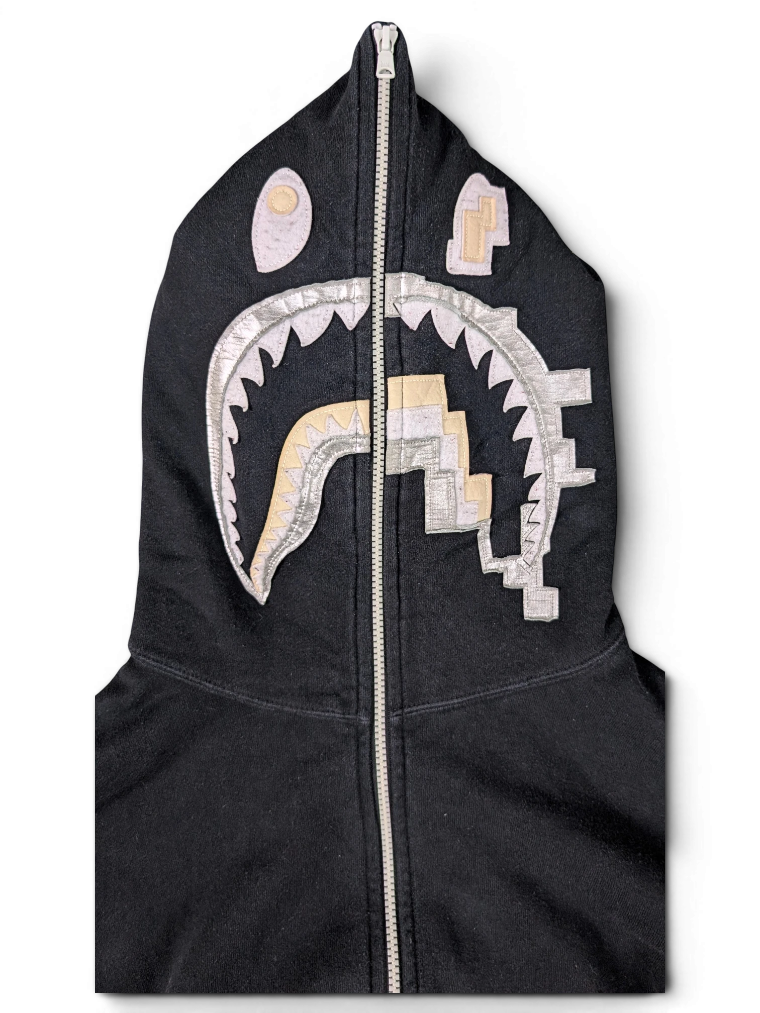 JAKE & IPI black Bape Shark hoodie with iconic metallic silver and gold teeth graphic on the full-zip hood