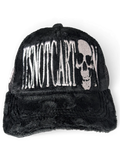 JAKE & IPI black faux fur trucker cap featuring white embroidered Itsnotcartoon text and a skull graphic