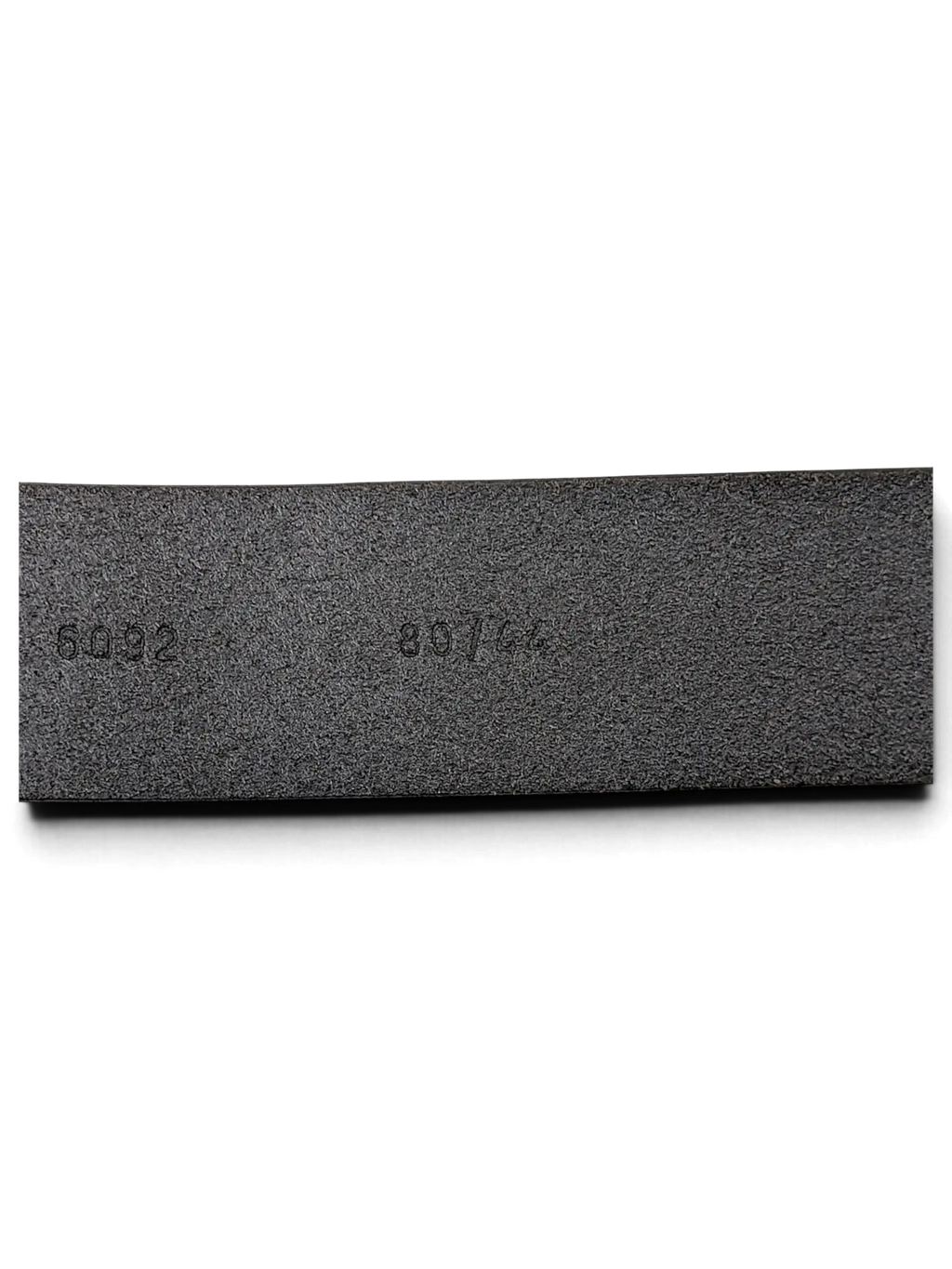 JAKE & IPI black leather belt interior detail showing embossed size and model numbers on the textured surface