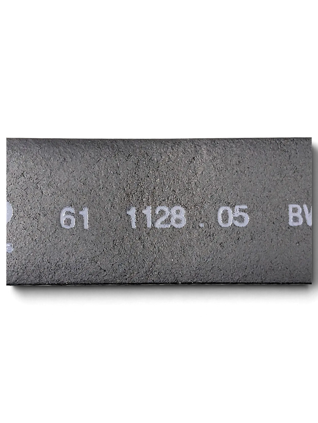 Close-up of the inner side of a JAKE & IPI LLOYD black leather belt showing embossed product code details