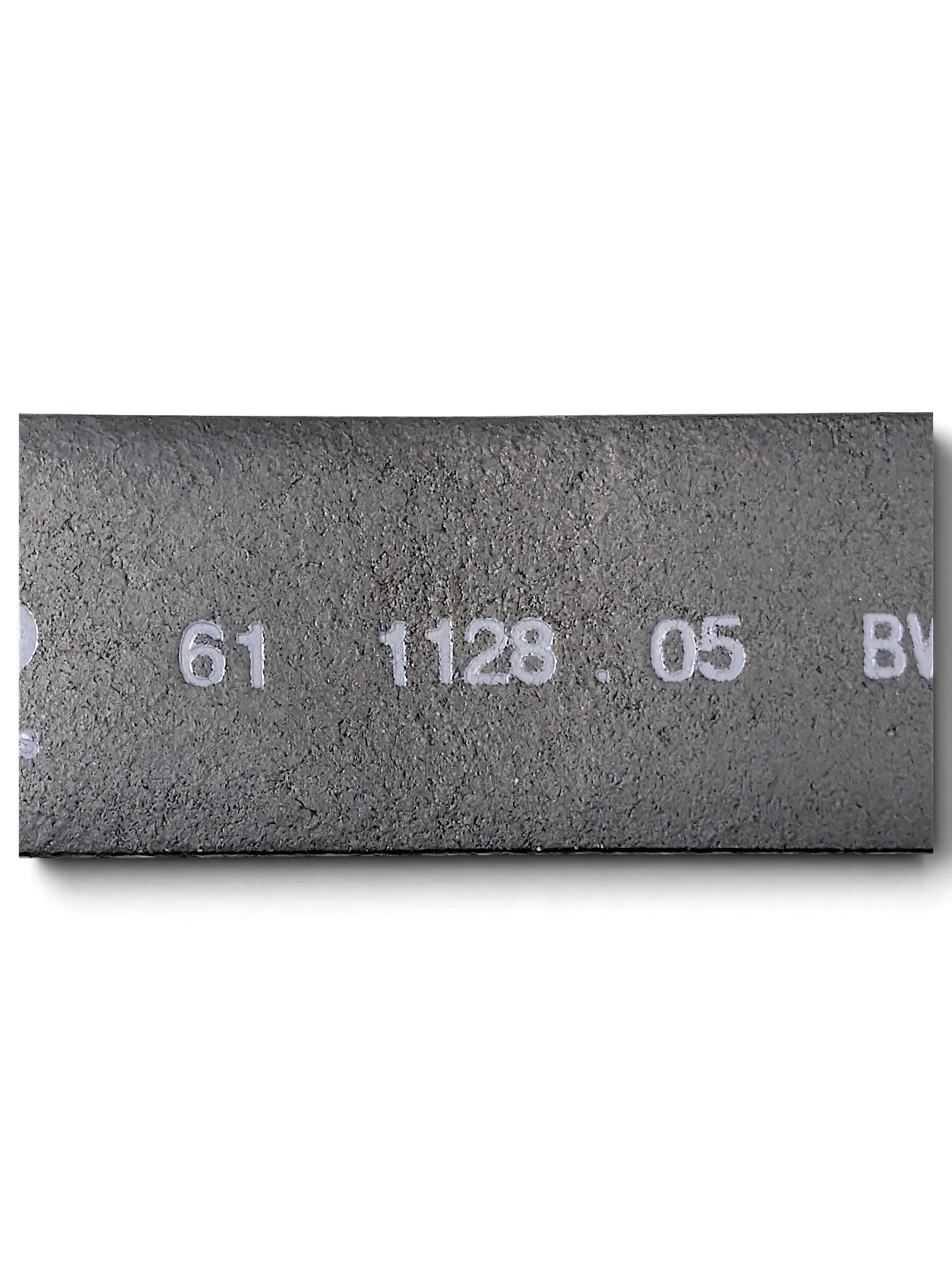 Close-up of the inner side of a JAKE & IPI LLOYD black leather belt showing embossed product code details