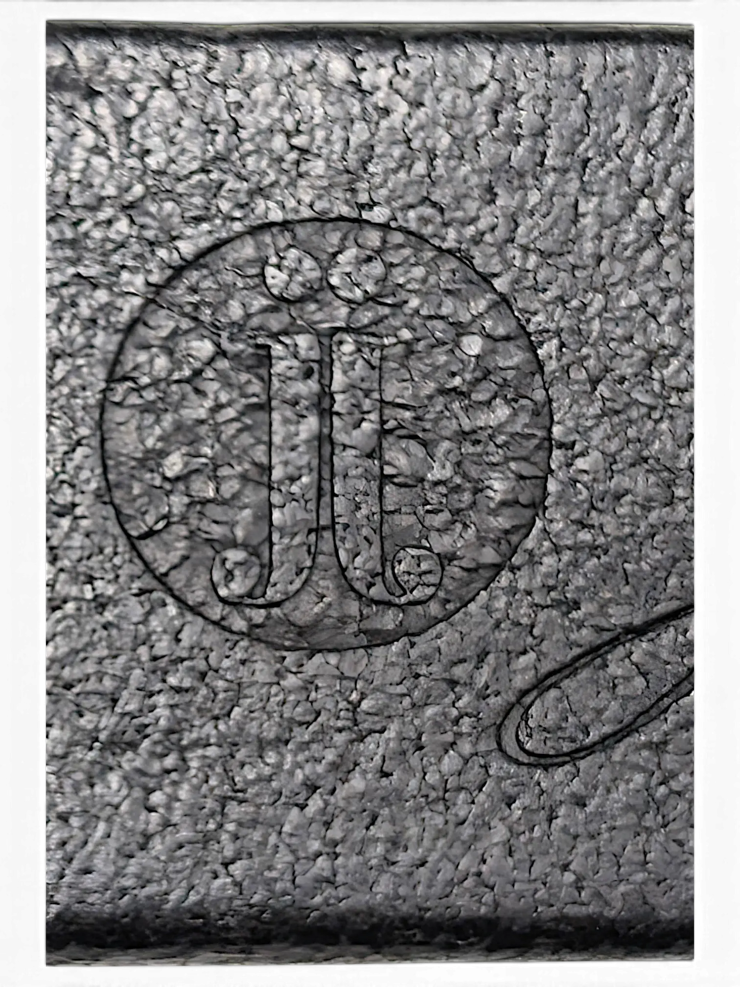 Close-up of the JAKE & IPI Jennifer Julia black leather belt featuring a circular embossed logo detail.