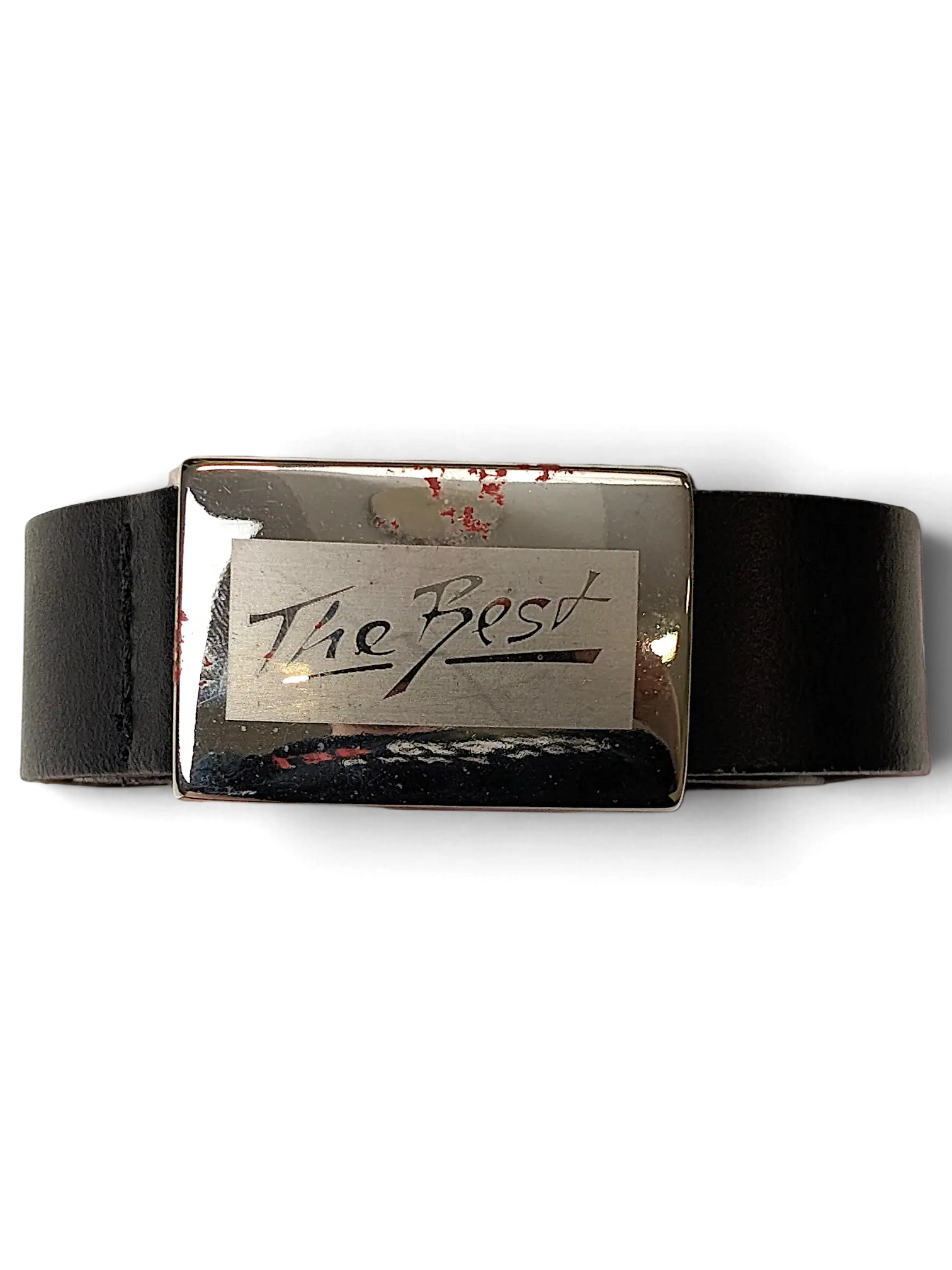 JAKE & IPI black leather belt featuring a silver rectangular buckle engraved with The Best text