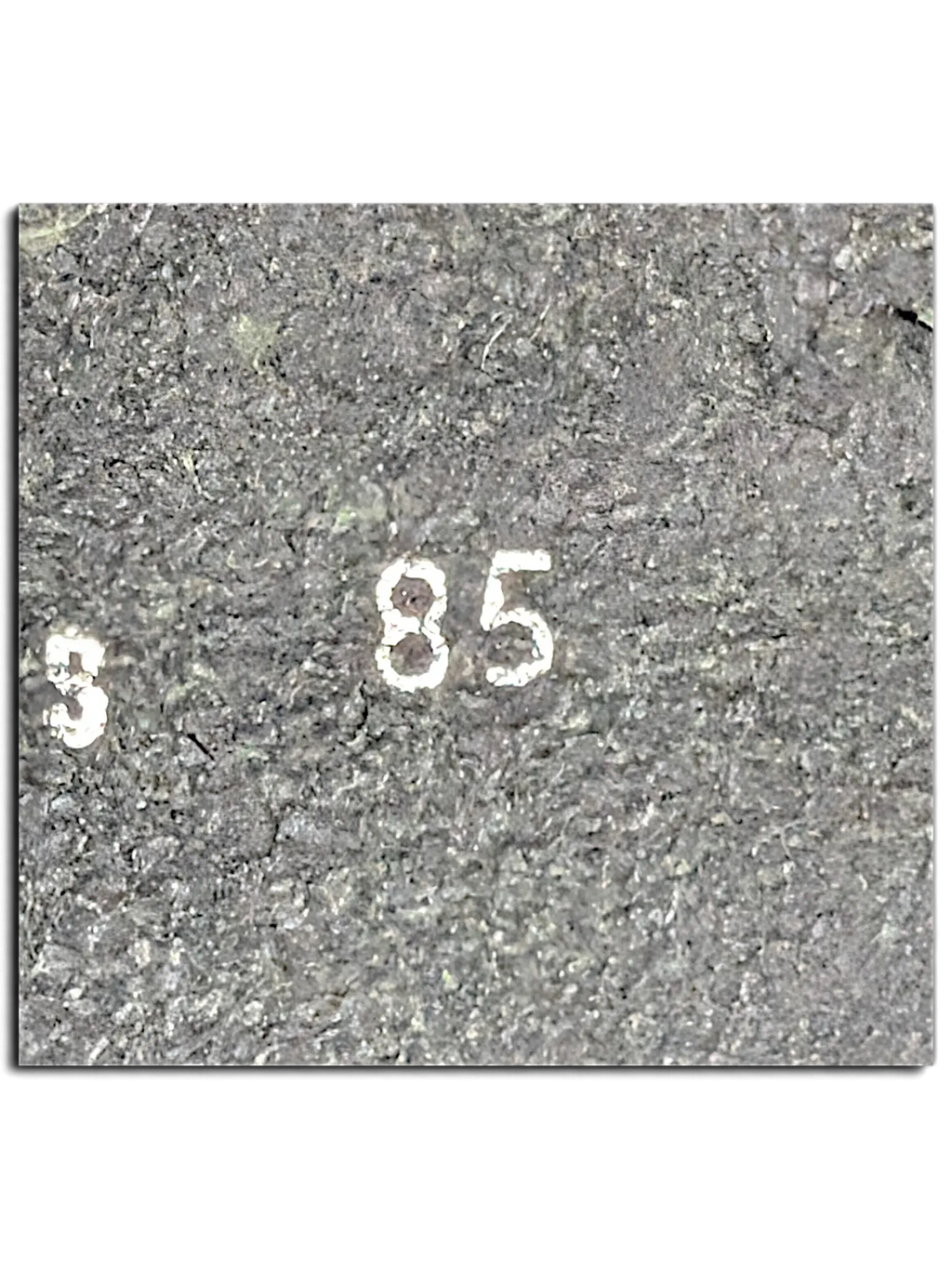 Close-up of the JAKE & IPI black leather belt showing the size 85 stamp on the textured material.