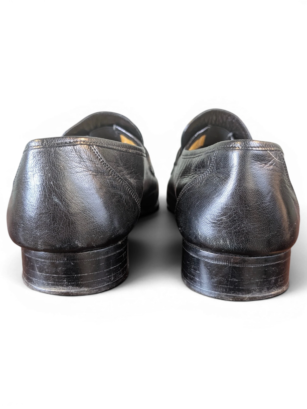 JAKE & IPI black leather loafers viewed from the back showing the stacked heels and textured leather finish
