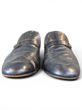 JAKE & IPI black leather loafers with a classic strap detail and textured finish, front view.