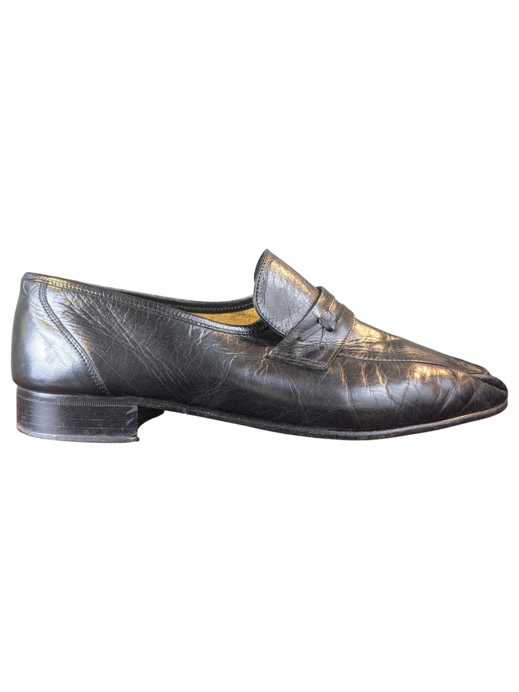 JAKE & IPI black leather penny loafers with a classic slip-on design and low heel, side view.