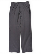JAKE & IPI black tailored suit trousers with a clean flat front design laid flat on a green surface.