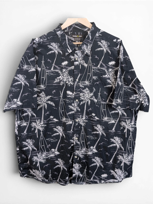 JAKE & IPI Atlas For Men black and white Hawaiian shirt with palm tree and sailboat print on a wooden hanger