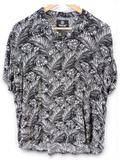JAKE & IPI black and white Hawaiian shirt with a tropical palm leaf print and short sleeves on a wooden hanger.