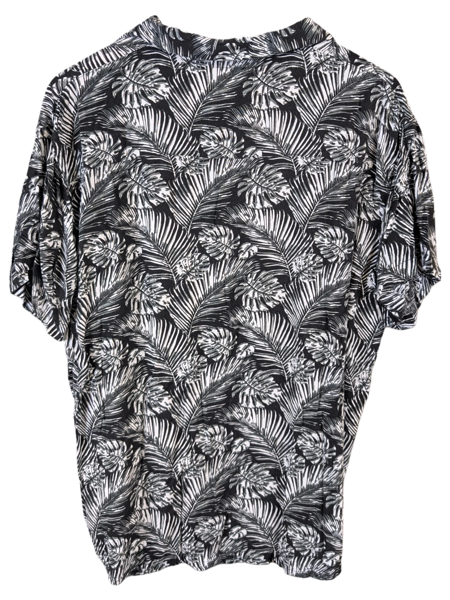 JAKE & IPI black and white Hawaiian shirt featuring a tropical palm leaf print on a wooden hanger