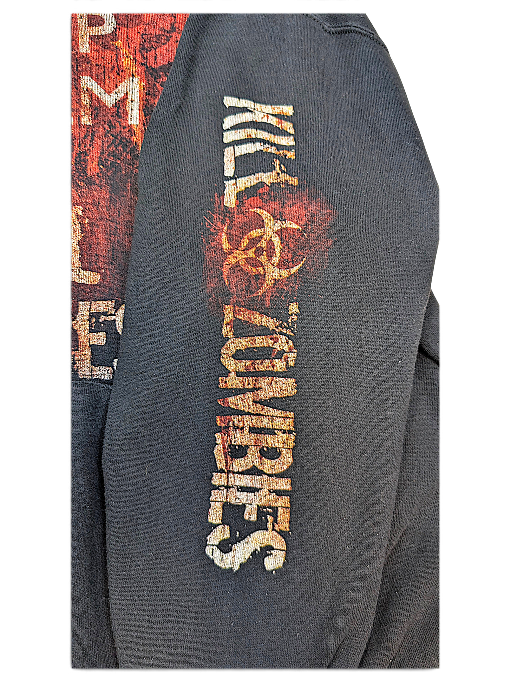 JAKE & IPI black hoodie sleeve featuring a distressed Kill Zombies graphic with a biohazard symbol in red and orange