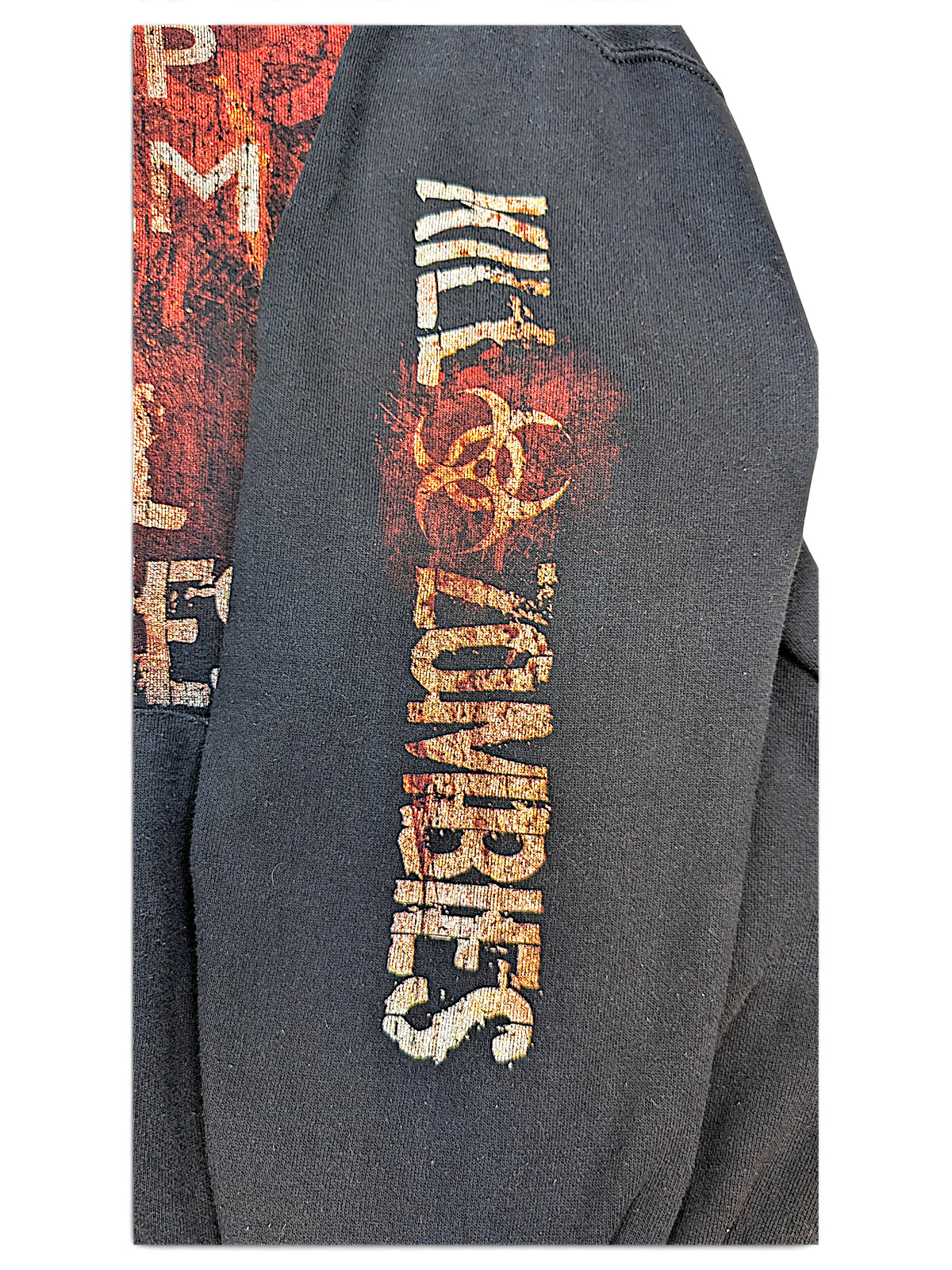 JAKE & IPI black hoodie sleeve featuring a distressed Kill Zombies graphic with a biohazard symbol in red and orange