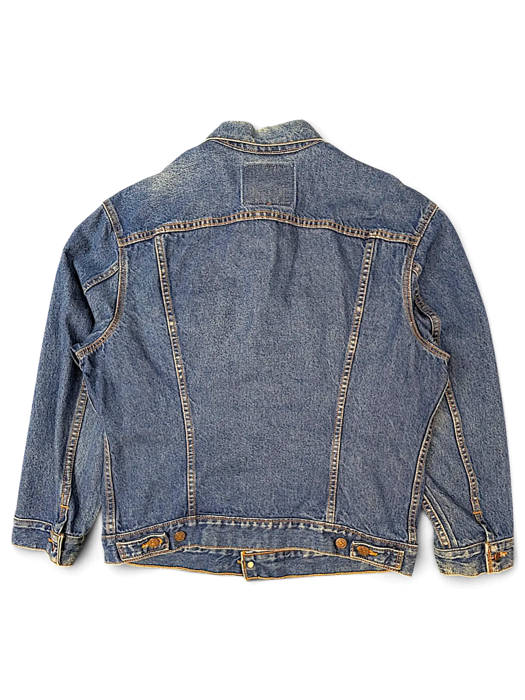 Back view of a vintage blue denim jacket from JAKE & IPI with classic stitching and button-tab waist details.