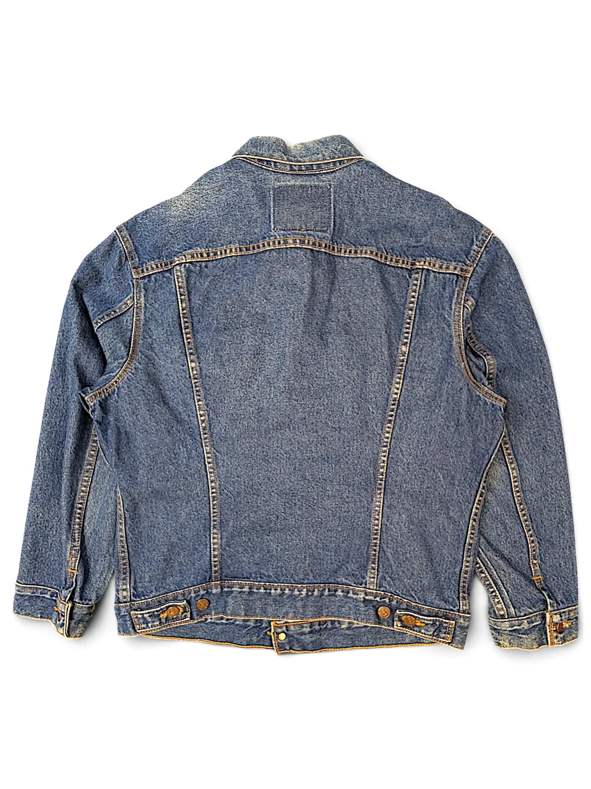 Back view of a vintage blue denim jacket from JAKE & IPI with classic stitching and button-tab waist details.