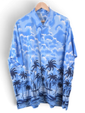 JAKE & IPI blue Hawaiian shirt featuring a tropical palm tree and cloud print on a button-down short sleeve design