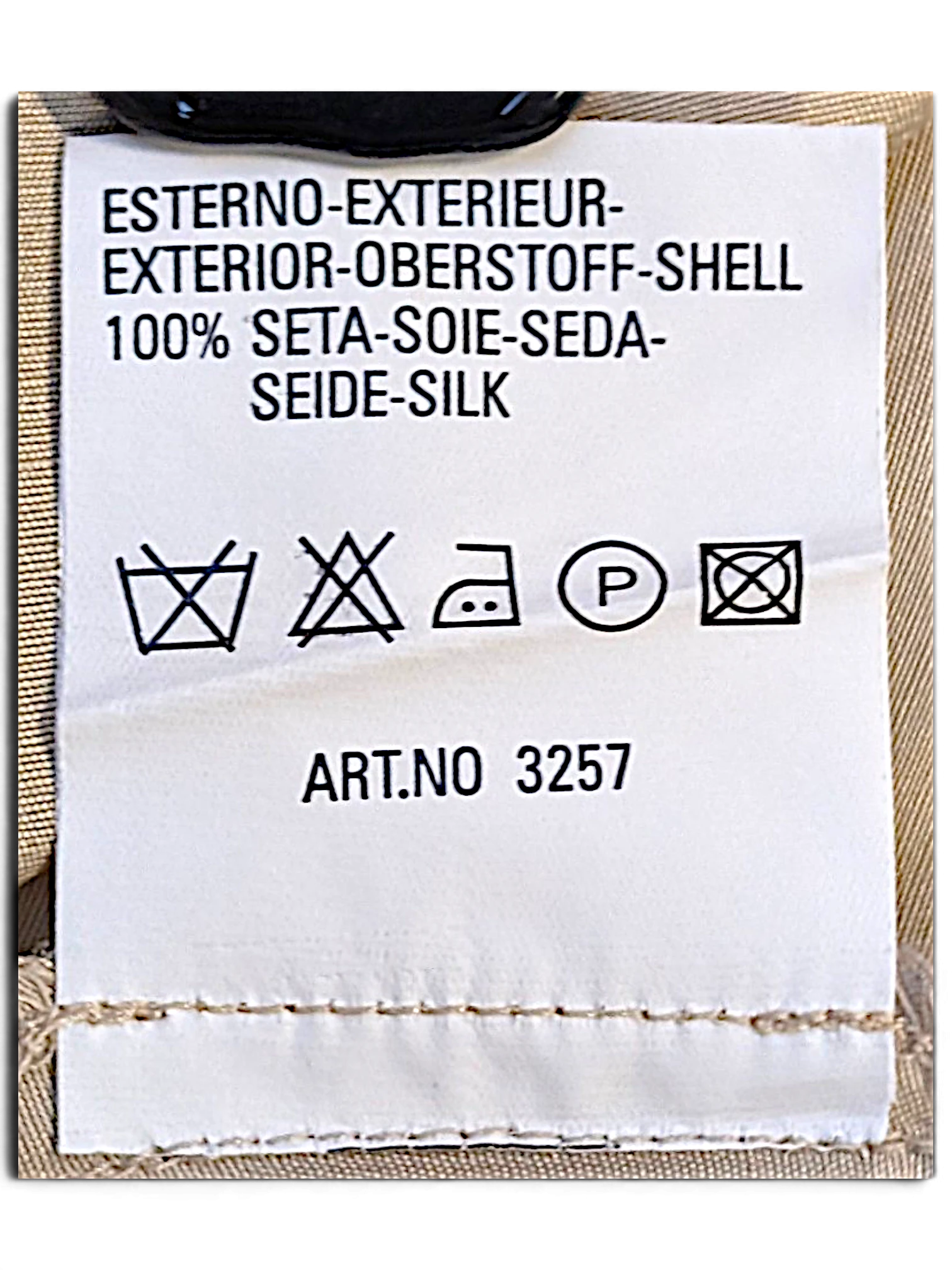 JAKE & IPI care label for Blunauta ivory silk trousers showing 100% silk composition and garment care instructions