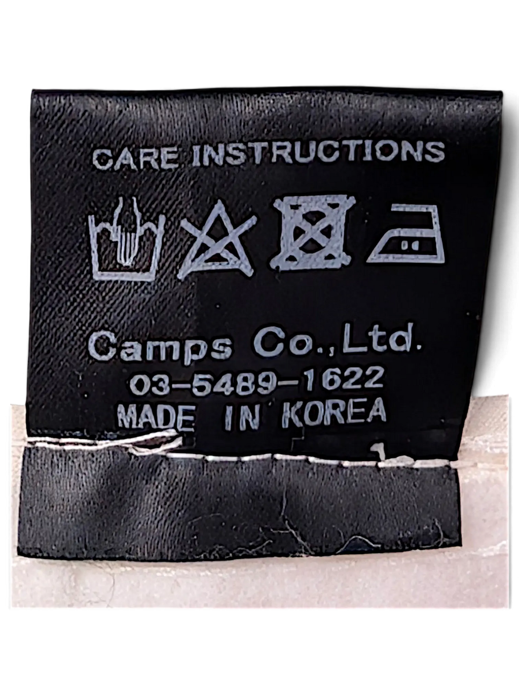 JAKE & IPI IBE Time Is On bucket hat black fabric care instruction label with laundry symbols and origin details