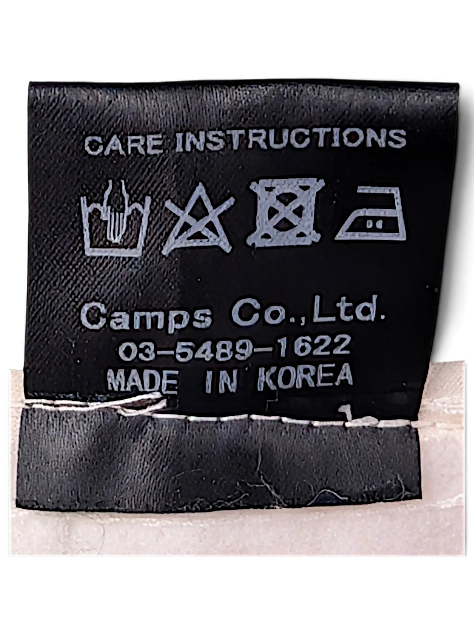 JAKE & IPI IBE Time Is On bucket hat black fabric care instruction label with laundry symbols and origin details